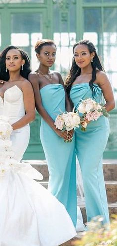 three bridesmaids in blue dresses posing for a photo