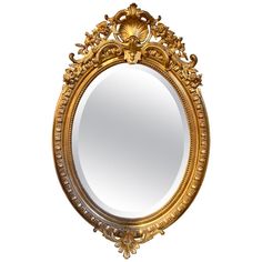 an ornate gold framed mirror on a white background