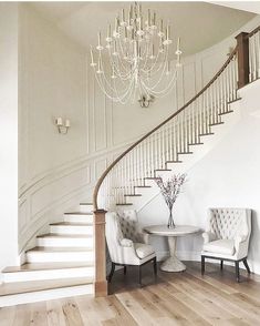 an instagram page with two chairs and a table in front of a staircase that leads up to the second floor