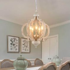 a chandelier hanging from the ceiling in a dining room