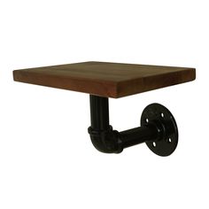 a square wooden table with metal wheels on the bottom and an iron pipe at the base