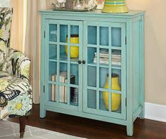 a blue cabinet with glass doors in a living room