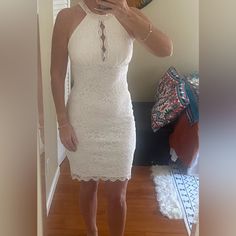 a woman taking a selfie in a white dress