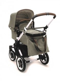 a baby stroller with a handlebar and seat in grey, brown and white