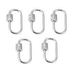 four silver metal hooks with diamonds on them