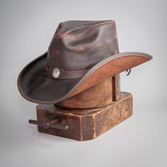 Welcome the Western Leather Cowboy Hat! This workhorse of a Cowboy hat is a dream. Handcrafted from a lightweight top grain leather will wear as if it is not there. Textured topgrain cowhide construction Boldly curved and classic shape Made in California, USA Brim 3" Crown 4" Size 6 up to a Size 8 Removable Sweatband Cowhide Leather Featherweight Buffalo Nickel Hat Band Sizing Info Measuring for the Western - Mens American Leather Cowboy Hat begins by wrapping a soft measuring tape (also known a Straw Cowgirl Hat, White Cowboy Hat, Brown Cowboy Hat, Hats For Big Heads, American Hat Makers, Leather Cowboy Hats, American Hat, Black Cowboy Hat, Black Cowgirl