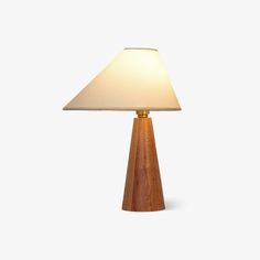 a small wooden table lamp with a white shade on the top and bottom part of it