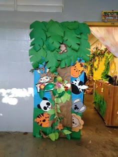 a cardboard tree with animals on it