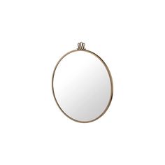 a round mirror sitting on top of a white wall