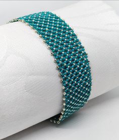 Teal- silver beacelet  Sometimes a simple but quite recorativevbracelet is required. This is such a beacelet!  The smoothness of the flat chenille stitch gives this bracelet an extra chick. I created this 18 cms long, IT closee with a slide ín magnetic clasp. The jewellery will be posted from Hungary via postal services. If you have any further questions, do not hesitate to contact me. Silver Tiny Beads Bracelet For Party, Silver Bracelets With Tiny Beads For Party, Silver Bracelet With Tiny Beads For Party, Elegant Turquoise Bracelets With Silver Beads, Elegant Handmade Silver Friendship Bracelet, Silver Bangle Bracelets With Tiny Beads, Silver Bangle Bracelet With Tiny Beads, Silver Beaded Bracelets With Round Beads, Silver Bead Bracelet