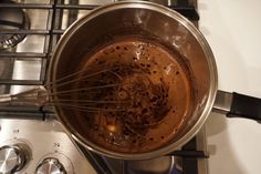 a pot filled with liquid sitting on top of a stove