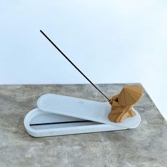 a wooden object with two sticks sticking out of it's sides on top of a table