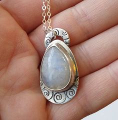 "This one of a kind pendant has a beautiful teardrop shaped Moonstone bezel set in Sterling Silver. The Silver the under the stone and the top circle where the chain connects is stamped with a spiral pattern. Hung on a 20\" Sterling chain." Hand Forged Teardrop Moonstone Jewelry, Artisan Teardrop Moonstone Jewelry, Moonstone Teardrop Pendant Jewelry, Unique Teardrop Stone-set Jewelry, Unique Teardrop Stone Setting Jewelry, Unique Teardrop Shaped Jewelry With Stone Setting, Blue Nile Jewelry, Metal Smithing, Spiral Pattern