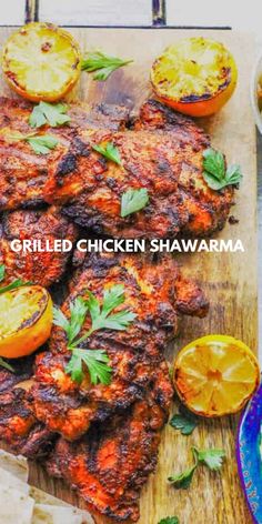 grilled chicken shawarma on a cutting board with lemons and parsley