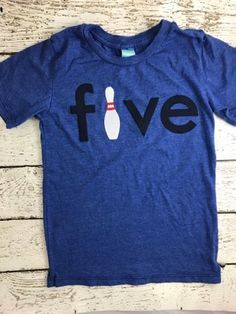 a blue t - shirt that says five with a bowling ball on the front and back