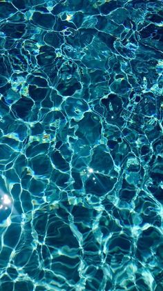 the water is blue and clear with little ripples on it's surface in this pool