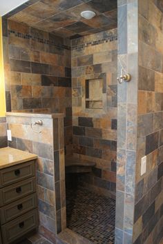 a walk in shower sitting inside of a bathroom next to a sink and counter top