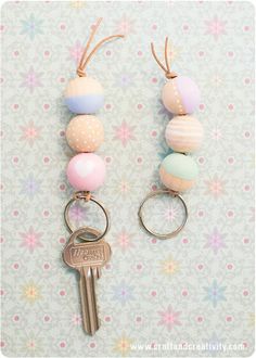 two key chains with different colored balls attached to them