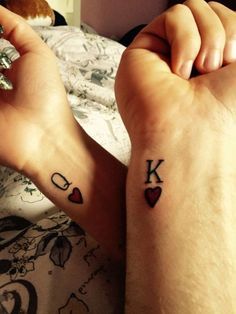 two people with matching tattoos on their feet, one has the letter k and the other has hearts