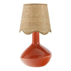 an orange table lamp with a burlap shade on the top and bottom part