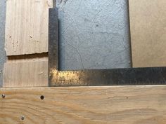 some pieces of wood are laying on the floor next to a ruler and screwdriver