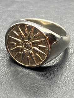 "The ring is made of 925 Sterling Silver Coin 17mm 11gr. ALL SIZES AVAILABLE Straight off the workshop bench! The classic design and quality of this ring makes this an item of jewelry to be worn and enjoyed for a lifetime. Beautiful in details ring inspired by the ancient Vergina sun Greek symbol. The design in the middle of the sun is a rosette flower which symbolizes beauty, purity, worship, fertilisation, earth and power according to ancient Greeks. A piece of history perfect for everyday jew Sun Jewelry Men, Greek Rings, Workshop Bench, Rosette Flower, Ancient Greek Jewelry, Greek Symbol, Greek Ring, Sun Ring, Mens Gold Jewelry