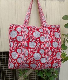 The Indian Hand Block Printed Cotton Quilted Women's Handbags from Rajasthan India. This handbag is completely Indian printed on good quality cotton. Cotton quilted Jhola Bag made by Indian Artisans, this cotton quilted shopping bag is totally unique and multi purpose. Use this for your grocery or as a travel bag. Perfect to suit all. Item :- Quilted Tote Bag Material: 100% Cotton Color - Same As Picture Style: Tote Bag Size in Inches:- Height-18" inch Approx Width- 18" inch Approx Handle-13" in Reversible Square Bags, Reversible Red Bag For Daily Use, Red Reversible Bag For Daily Use, Rectangular Red Shoulder Bag For Market, Red Rectangular Shoulder Bag For Market, Handmade Red Canvas Tote Bag, Traditional Rectangular Everyday Bag, Traditional Everyday Rectangular Bag, Rectangular Block Print Bags For Daily Use