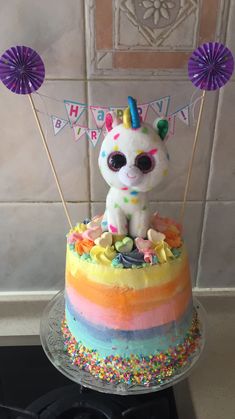 a birthday cake with a unicorn on top