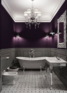 a bathroom with purple walls and white fixtures