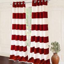 a red and white striped curtain hanging in front of a window next to a potted plant