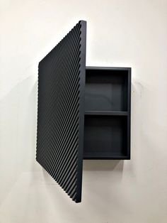 a black shelf mounted to the side of a wall