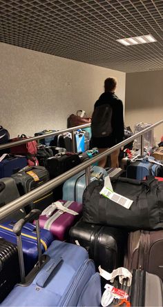 luggage is piled on the conveyor belt at an airport