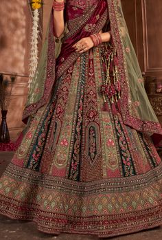 This stunning lehenga choli dress is crafted from luxurious fancy silk, creating a flawless look for any special occasion. Elevate your style with the vibrant color and elegant design, sure to turn heads and make you feel confident and beautiful! Perfect for adding a touch of glamour to any event. LEHENGA FABRIC: Velvet, SILK LEHENGA WITH HEAVY HANDWORK AND ZARKAN BLOUSE FABRIC: SILK DUPATTA: NET, VELVET WITH DOUBLE DUPATTA SIZING: Can be stitched upto 42 inches bust and waist SHIPPING: The product will be shipped within 1 - 2 weeks from the date of purchase. Stitched item will ship within 2-3 weeks from the date of the order All stitched products are final sale. We will contact you within 1-2 days from the date of order to confirm your measurements. Stitching Option - We will email you th Bridal Lehenga Maroon, Green Bridal Lehenga, Women Suits Party, Blue Bridal Lehenga, Double Dupatta, Maroon And Green, Suits Accessories, Choli Dress, Blue Bridal