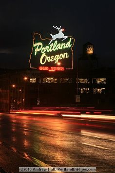 the sign for portland oregon is lit up at night