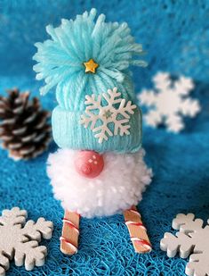 there is a small snowman wearing a blue hat