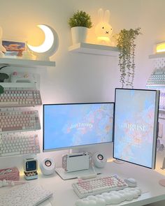 two computer monitors sitting next to each other on top of a white desk in a room