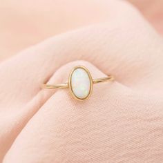 Opal Solitaire Ring 10kt Solid Gold Our solid gold opal solitaire ring is a dainty and delicate forever piece that you'll cherish for years to come. The sparkly opal center glistens in the light beautifully. ✨ DETAILS - 10kt solid gold - Opal center stone - 1.5mm thick band - Available in sizes 6-9 - Additional ring sizes available upon request, just contact us! See more of our fine jewelry here: https://www.etsy.com/shop/amandadeer?ref=simple-shop-header-name&listing_id=1148615496&section_id=36 Solitaire Opal Ring, Gold Solitaire Opal Promise Ring, Opal Solitaire Ring Gift, Elegant Gold Solitaire Opal Ring, Minimalist 14k Gold Solitaire Opal Ring, Deer Jewelry, Opal Solitaire Ring, Rainbow Jewelry, Baroque Pearl Necklace