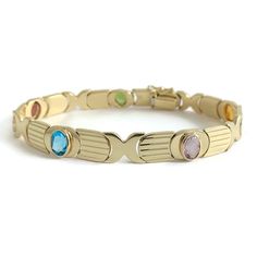 Vintage 1960's Italian Multicolored Gemstone Bracelet 14K Yellow Gold, 15.79 Gr This is a beautiful gemstone bracelet! Let us know if you have any questions. Circa: 1960's Gemstones: 5 oval gemstones 6 mm x 4.5 mm, 2.50 ctw (peridot, garnet, London blue topaz, amethyst, citrine) Metal: 14K yellow gold Weight: 15.79 grams Stamped: 14K, ItalyLength: 7.25 inches Width: 8.4 mm Clasp: snap clasp with safety latch V0086 Fine Jewelry Bracelets, London Blue, London Blue Topaz, Bracelets And Charms, Gemstone Bracelet, Chain Link Bracelet, Blue Topaz, Citrine, Garnet