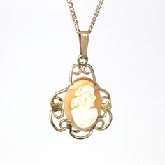 "Classic vintage 1940s retro 12k rose gold filled cameo necklace! This lovely statement pendant depicts a gorgeous woman in white carved shell, with a salmon colored background. The pendant is adorned in scrolled designs with yellow gold filled butterflies on either side of the cameo. The piece hangs from its original matching 18.25 inch 12k rose gold filled chain. A stunning piece of 1940s era jewelry, featuring a beautiful carved cameo! *Sale - price reduced from $120 USD to $110 USD.  ERA - C 60s Jewelry, Cameo Pendant Necklace, Woman In White, Purple Gems, Pendant Bails, Vintage Wedding Band, Vintage Cameo, Colored Background, Carved Shell