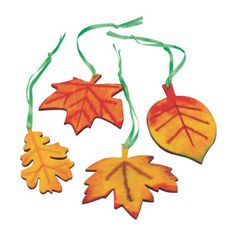 three autumn leaf ornaments hanging from green string