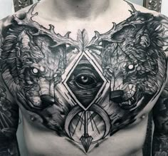 a man's chest with two wolfs and an all seeing eye tattoo on it