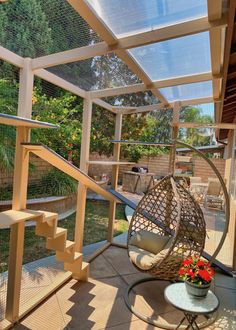 a patio with a hanging chair and potted plant