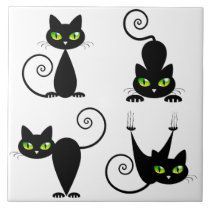 four black cats with green eyes and swirls on their tails, sitting in different positions