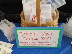 there is a sign that says tackle your table box next to some plastic containers on the table