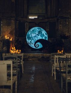 the inside of a restaurant with tables and chairs set up in front of a full moon