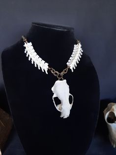 This is a Gorgeous Mink Skull necklace! This Necklace Has 16 EXTRA Large Rattlesnake Vertebrae Bones, With 8 On Either Side on The Mink Skull.  The Mink Skull Itself is a Large Mink Skull, It is in great Condition and It Has All of The Teeth. They are Glued in Very Well. The Bronze Chain It Comes With is Adjustable up to 24 Inches. All Items Ship Within 1-3 Days via USPS First Class Service, With Some Upgrades Available Also. Shipping on This Necklace Will be 5.00 Additional Items are Free! International Shipping Will Be 20.00, And All Additional Items Are FREE! International Shipping May Take 2 - 6 Weeks To Deliver. I Always Love to Accommodate Custom Orders! If you Have Something in Mind , Please Message me. Have a Drawing or a Photo of Your Inspiration and Send it to Me! And Also Please Animal Skull Necklace, White Gothic Skull Jewelry, Handmade Bone Jewelry For Halloween, Unique Handmade Skull Necklace, Handmade Gothic White Jewelry, Real Skull, Witch Necklace, Human Bones, Necklace Gothic