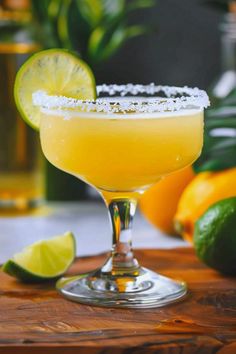 a margarita sitting on top of a wooden cutting board