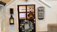 a dog house with a wreath and mailboxes on the front door to it