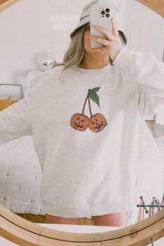 This Cute and Comfy Halloween Sweatshirt its the perfect addition to your fall weather or Halloween event. Its Trendy, Halloween graphics- with cherry Pumpkins. Its Halloween yall take this sweatshirt to the Pumpkin Patch and be a  Coquette Girlie this fall.  * Q U I C K * F A C T S * ♥️ 100% Soft cotton ♥️Design is high quality digital print ♥️ Wash and dry normally. Do not iron directly on the print. * S I Z I N G * ♥️ Sizing is unisex so runs like men's, though not overly large ♥️Most women f Trendy Halloween Shirts, Cute Cotton Halloween Sweatshirt, Pumpkin Patch Shirts, Bloom Bar, Its Halloween, Halloween Coquette, Coquette Clothing, Girly Halloween, Spooky Sweatshirt