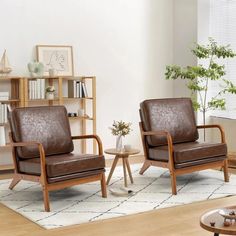 two brown leather chairs sitting next to each other on top of a white rug in a living room